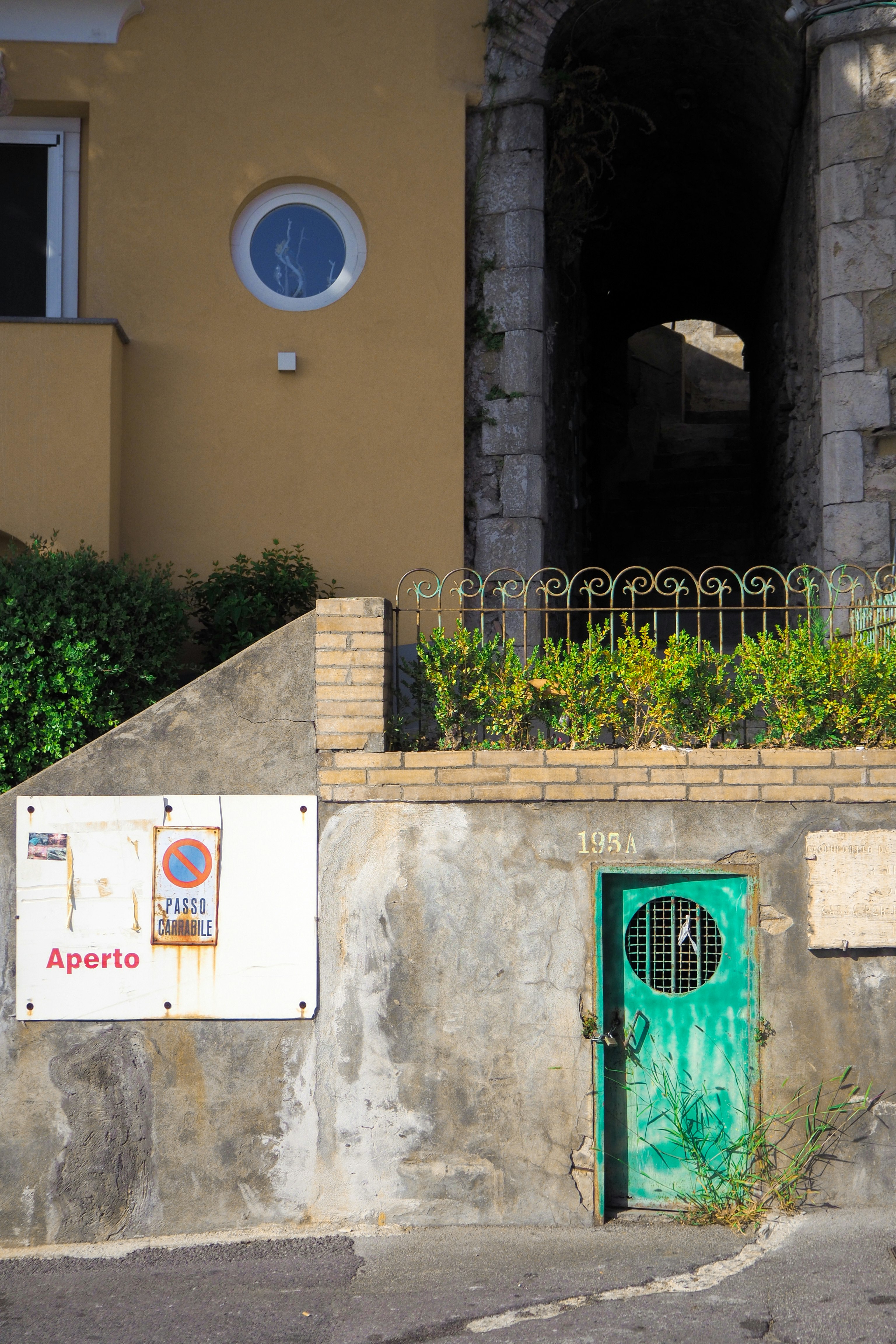 brown concrete building with green door